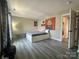Comfortable bedroom features wood floors, artwork, and a door to an adjoining space at 12564 Jessica Pl, Charlotte, NC 28269