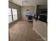 Bright dining area featuring tile flooring, natural light, and a breakfast bar that adds style and functionality to the space at 12564 Jessica Pl, Charlotte, NC 28269