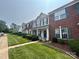 Row of townhomes showcases well-maintained lawns, manicured shrubs, and complementary exterior colors for curb appeal at 12564 Jessica Pl, Charlotte, NC 28269