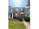 Charming two-story townhome features a classic brick facade, well-manicured lawn, and inviting front entrance at 12564 Jessica Pl, Charlotte, NC 28269