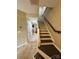 Inviting hallway featuring tile and wood floors, a staircase, and neutral colors, perfect for a welcoming home at 12564 Jessica Pl, Charlotte, NC 28269