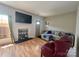 Inviting living room with hardwood floors, large TV, and cozy seating for a comfortable living space at 12564 Jessica Pl, Charlotte, NC 28269