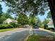 Scenic neighborhood street with mature trees, providing a serene and inviting atmosphere for residents at 12564 Jessica Pl, Charlotte, NC 28269