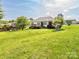 Expansive backyard with a wooden deck, mature trees, and a well-maintained lawn at 1271 Applewood Ln, York, SC 29745