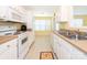 Functional kitchen with white cabinets, essential appliances, and a sunny breakfast nook at 1271 Applewood Ln, York, SC 29745