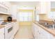 Functional kitchen with white appliances, countertops, and ample cabinet space at 1271 Applewood Ln, York, SC 29745