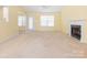 Cozy living room with neutral carpet, featuring a fireplace, and a door that leads to the exterior at 1271 Applewood Ln, York, SC 29745