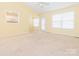 Bright living area with large windows, neutral carpet, and views to the kitchen at 1271 Applewood Ln, York, SC 29745