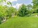Expansive backyard lush green grass and mature trees providing ample privacy at 128 W End St, Chester, SC 29706