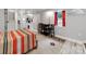 Basement bedroom with dining area and kitchenette, featuring a colorful rug and red curtains at 128 W End St, Chester, SC 29706