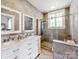 Modern bathroom featuring double sinks with marble countertops and a spacious glass-enclosed shower at 128 W End St, Chester, SC 29706