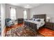 Spacious bedroom with hardwood floors, a large bed, and ample natural light from the windows at 128 W End St, Chester, SC 29706
