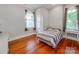 Well-lit bedroom with classic hardwood floors and neutral decor at 128 W End St, Chester, SC 29706