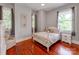 Cozy bedroom featuring hardwood floors and large windows at 128 W End St, Chester, SC 29706