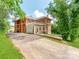 Exterior view of a brick home showing garage and outdoor deck at 128 W End St, Chester, SC 29706