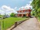 Beautiful red brick home with a long driveway and well-maintained green lawn at 128 W End St, Chester, SC 29706