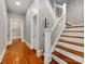 Inviting foyer featuring hardwood floors and a staircase with white railings and wooden steps at 128 W End St, Chester, SC 29706