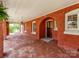 Exterior view of a covered red brick porch with an arched doorway at 128 W End St, Chester, SC 29706