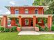 Classic brick porch with white columns, hanging plants, and inviting entrance at 128 W End St, Chester, SC 29706