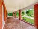 A long, brick-paved porch with hanging plants and a view of the street at 128 W End St, Chester, SC 29706