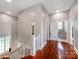 Upstairs hallway with hardwood floors and a view of the bathroom at 128 W End St, Chester, SC 29706