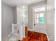 Hallway with hardwood floors and a staircase with white wooden railings at 128 W End St, Chester, SC 29706