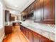 Spacious kitchen with dark cabinets, granite countertops, and modern appliances at 128 W End St, Chester, SC 29706