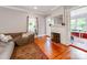 Bright living room featuring hardwood floors, fireplace and access to sunroom at 128 W End St, Chester, SC 29706