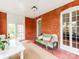 Sunroom features red brick walls, light colored floor and lots of natural light at 128 W End St, Chester, SC 29706