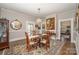 Traditional dining room featuring a wooden table, elegant chandelier, and decorative area rug at 132 N Confederate Ave, Rock Hill, SC 29730
