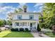 Charming two-story home with light siding, brick chimney, manicured lawn, and welcoming front porch at 132 N Confederate Ave, Rock Hill, SC 29730