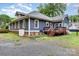 Rear view of house, featuring a wood deck, a brick foundation and a quaint gravel area at 14115 Old Statesville Rd, Huntersville, NC 28078