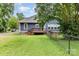 A backyard featuring a wood deck with backyard views, a fence and green grass at 14115 Old Statesville Rd, Huntersville, NC 28078