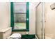 Bright bathroom featuring a shower and a window with green trim providing natural light and views of the outside at 14115 Old Statesville Rd, Huntersville, NC 28078