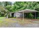 Detached garage with a carport, showing its potential for storage or a workshop at 14115 Old Statesville Rd, Huntersville, NC 28078