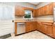 Cozy kitchen showcasing oak cabinets, stainless steel dishwasher and linoleum flooring at 14115 Old Statesville Rd, Huntersville, NC 28078