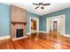 Charming living room boasting a brick fireplace and gleaming hardwood floors at 14115 Old Statesville Rd, Huntersville, NC 28078
