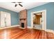 Inviting living room featuring a brick fireplace and gleaming hardwood floors at 14115 Old Statesville Rd, Huntersville, NC 28078
