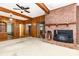 Living room featuring a brick fireplace, wood paneling, and doorways to other rooms at 14115 Old Statesville Rd, Huntersville, NC 28078
