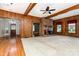 Open-concept living room featuring a brick fireplace, wood paneling and wood floors at 14115 Old Statesville Rd, Huntersville, NC 28078