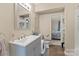 Well-lit bathroom featuring a modern vanity, toilet, and convenient storage options at 1425 3Rd Street Ne Pl, Hickory, NC 28601
