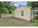 A charming home featuring yellow siding, complemented by a gravel driveway and a secure wooden fence at 1425 3Rd Street Ne Pl, Hickory, NC 28601