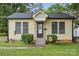 Charming home with a welcoming porch, black door, and manicured shrubbery enhancing its curb appeal at 1425 3Rd Street Ne Pl, Hickory, NC 28601