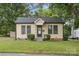 Charming yellow home featuring a welcoming entrance, well-maintained lawn, and mature trees at 1425 3Rd Street Ne Pl, Hickory, NC 28601