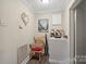 Charming hallway enhanced by decorative wall art, lighting, rocking chair, and neutral paint scheme at 1425 3Rd Street Ne Pl, Hickory, NC 28601