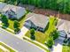 Aerial view of home with mature landscaping, a well-manicured lawn, and a paved driveway at 14727 Brannock Hills Dr, Charlotte, NC 28278