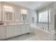 Elegant bathroom with double sink vanity, soaking tub, and bright natural light creating a spa-like atmosphere at 14727 Brannock Hills Dr, Charlotte, NC 28278