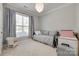 Cozy bedroom featuring soft carpet, neutral paint, ample natural light, and space for a bed and furniture at 14727 Brannock Hills Dr, Charlotte, NC 28278