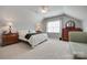 Bedroom featuring a bed, lamps, dresser, and a chair, offering a comfortable and inviting space at 14727 Brannock Hills Dr, Charlotte, NC 28278