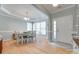 Bright dining room featuring a tray ceiling, hardwood floors, and ample natural light from the large windows at 14727 Brannock Hills Dr, Charlotte, NC 28278